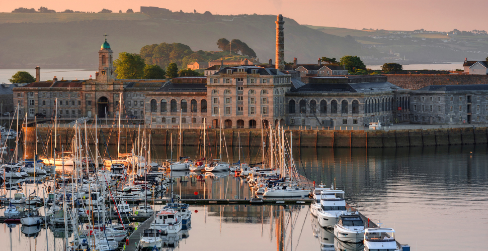 The Royal William Yard in Plymouth with water in front of it